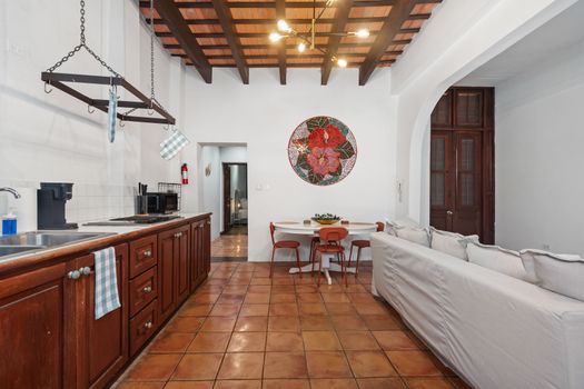 Unwind in comfort on the cozy couch, perfectly set in this welcoming dining area.