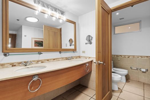 Expansive bathroom vanity with dual sinks, perfect for getting ready with ease and comfort.