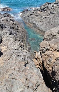 Discover a hidden gem! Crystal-clear turquoise waters wind through dramatic rock formations, leading to the open ocean.
