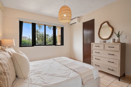 Wake up to natural light and refreshing breezes in this beautifully decorated master suite with outdoor access.