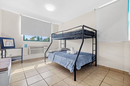 Enjoy the comfort of our clean and contemporary room, featuring a spacious bunk bed and large windows letting in plenty of natural light.