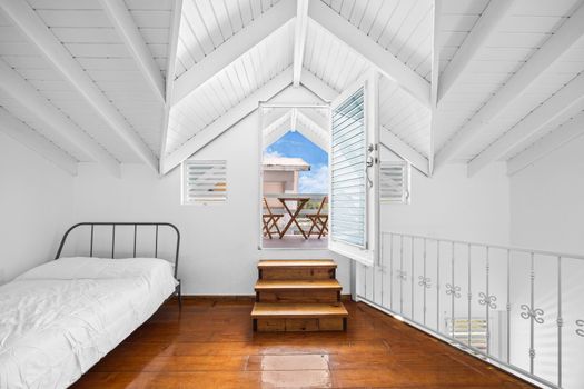 bedroom with private balcony, bed, soft linens and pillows