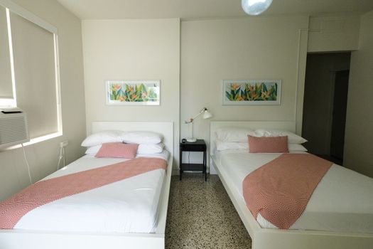 Ideal for friends or family, this room offers two comfortable twin beds, each beautifully made with fresh linens, ensuring a restful night's sleep for everyone.