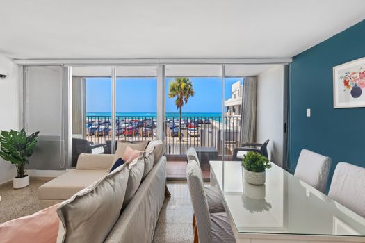 Large windows offering panoramic views of the Caribbean Sea and the historic streets below.