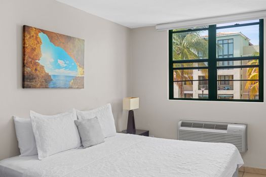 Wake up to picturesque views in this charming bedroom that promises comfort and tranquility.