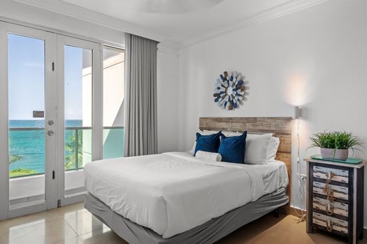 Immerse yourself in coastal charm with this beautifully decorated bedroom, offering two spacious beds and magnificent sea views, making every moment of your stay unforgettable.
