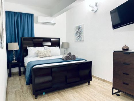 Experience restful nights in our comfortable main bedroom, boasting a plush queen-size bed and a powerful air conditioner to keep you cool and relaxed.