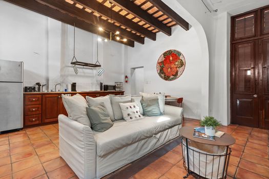 The spacious living room offers a cozy couch and a stylish coffee table, creating the perfect setting for relaxing or hosting gatherings.