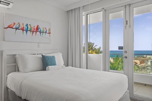 Cozy and well-decorated sleeping area with two comfortable beds. Charming artwork and soft lighting create a serene ambiance.