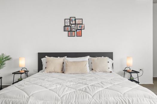 Minimalist elegance in a bedroom that's a blend of comfort, style, and tranquility, complete with inspiring art.