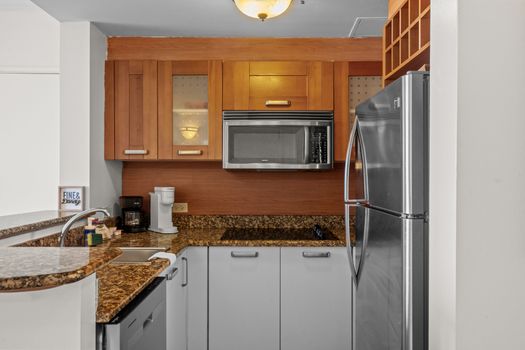 Seamless studio living. This wide-angle view showcases the thoughtful layout, connecting your comfortable sleeping area to a convenient and well-equipped kitchenette.