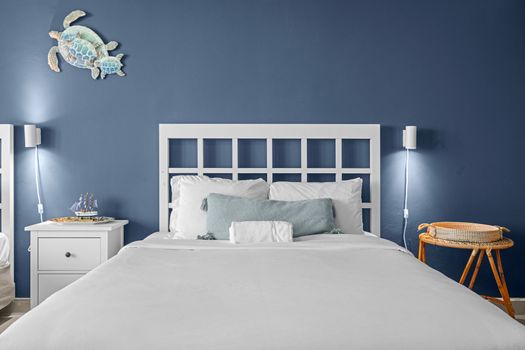 Experience ultimate comfort in this beautifully designed bedroom, featuring a striking accent wall and ample natural light pouring in from the large glass doors.