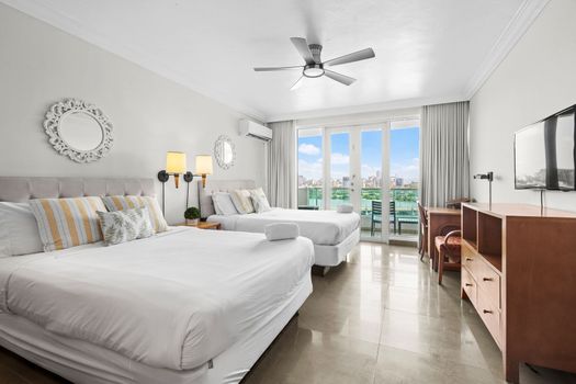 Spacious sleeping area with two inviting beds, adorned with tasteful decor and soft linens.
