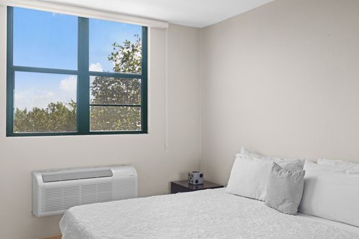 Wake up to the sight of blue skies in this airy bedroom, where comfort meets calm.v