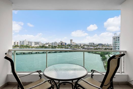 Step out onto your expansive private balcony and be captivated by the sweeping views of the Condado Lagoon and the San Juan skyline. This is your perfect spot for morning coffee or evening cocktails with a view.