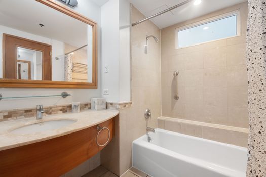 Relax and rejuvenate in our clean, contemporary bathroom featuring a full tub and shower