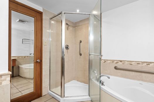 Spacious and functional bathroom offering a large mirror, ample counter space, and modern fixtures.