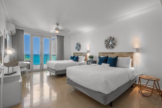 This well-designed room combines comfort and convenience, with two plush beds, a compact dining set, and direct access to a balcony boasting picturesque ocean views.