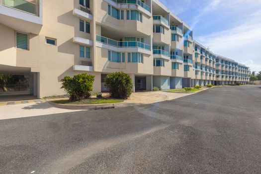 Stunning modern condominium building with beautiful architecture and lush landscaping.