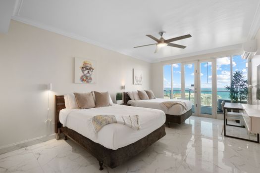 Comfortable and chic! Two plush beds await, with beautiful ocean views and charming decor for a delightful stay.