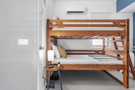 Discover minimalist comfort in our modern bunk bed room, designed for simplicity and efficiency.