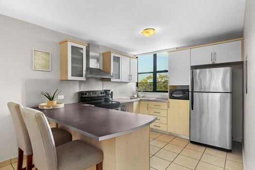 Modern and fully-equipped kitchen with a convenient breakfast bar for quick meals and social cooking.
