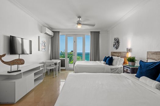 Wake up to breathtaking ocean views from your comfortable king and queen size beds, with direct access to your private balcony overlooking the sparkling Caribbean Sea.