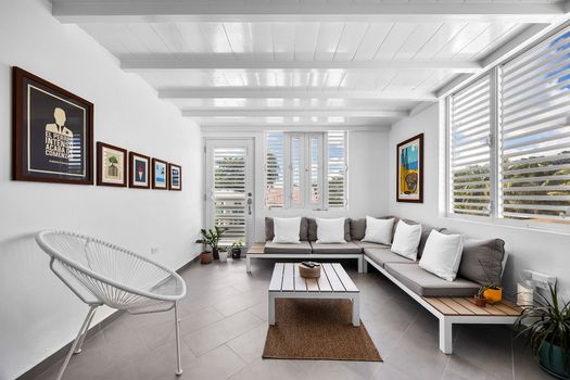 Relax in the inviting living space, complete with a comfy sofa and a bright window that fills the room with daylight – perfect for reading, lounging, or streaming your favorite shows.