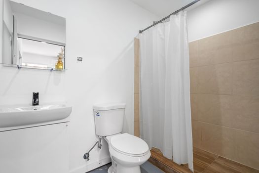 Bright and clean bathroom featuring a minimalist mirror and contemporary design for a relaxing pamper session.