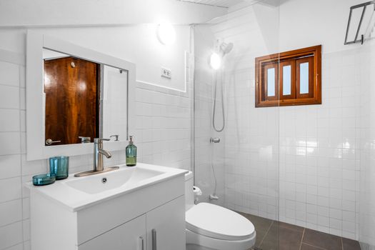 Freshen up in a sleek bathroom featuring a walk-in shower and full vanity.