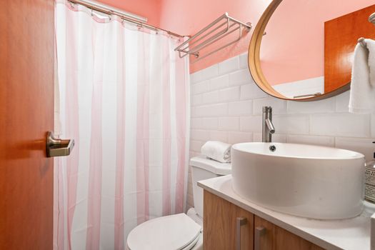 Modern & Refreshing: Step into our clean and contemporary bathroom, featuring a stylish vessel sink, pristine white subway tiles, and a vibrant accent wall that adds a pop of color.