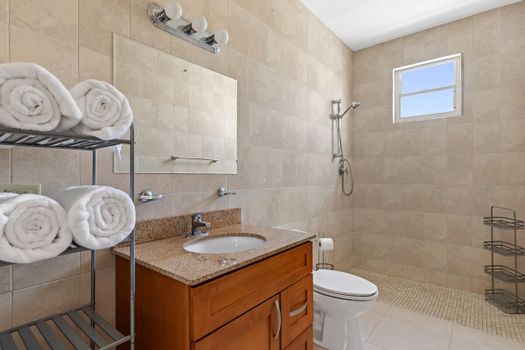 Experience tranquility and unwind in the pristine ambiance of this inviting bathroom sanctuary.