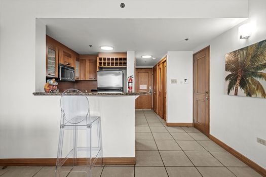 Chic breakfast bar with a clear stool, offering a charming spot for a meal or drink.