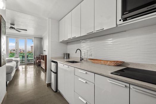 Sleek, compact kitchen leading to a bright, spacious studio with stunning views.