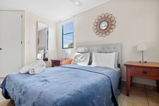 Experience tranquility in our Airbnb haven with a cozy queen-sized bed and plush blue comforter.