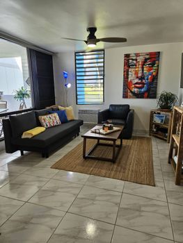 Our modern and inviting living area is your perfect retreat. Sink into the plush sofa or armchair, enjoy the artistic touches, and feel at home in this bright and comfortable space.