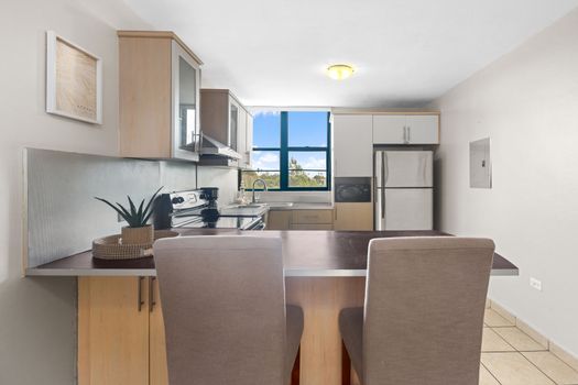 Contemporary kitchen space with a view, equipped with everything you need to whip up your favorite meals.