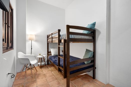 A cozy bunk bed arrangement in a sleek, modern minimalist room—ideal for friends or families traveling together.