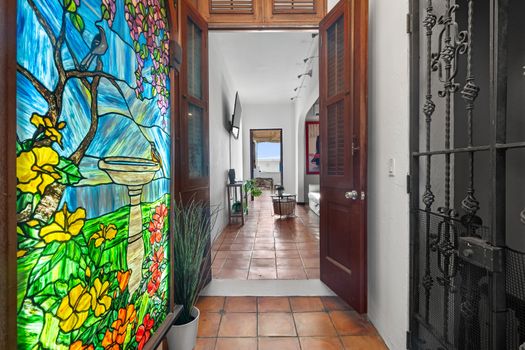 Welcome to our beautiful and cozy home! You’ll be greeted by a stunning stained glass window as you enter the hallway. The hallway leads to a spacious living room with a view of the ocean. The perfect place to relax after a long day of exploring the city.