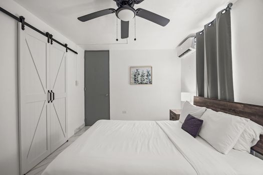 Spacious master bedroom with elegant wooden frame.