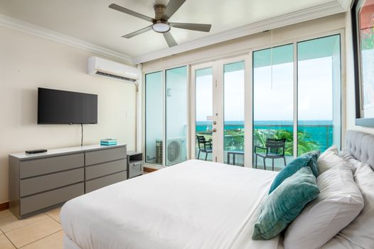 Wake up to paradise! Your luxurious King bed faces stunning ocean views, with direct access to your private balcony.