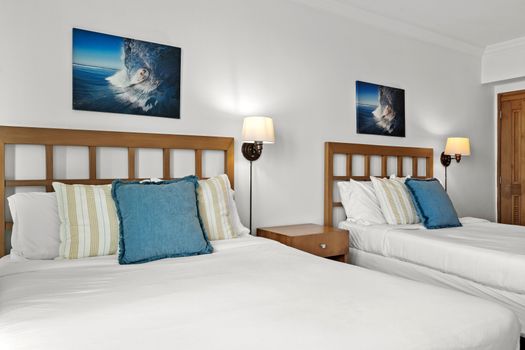 Comfortable and stylish studio with two inviting beds, offering a restful night's sleep.