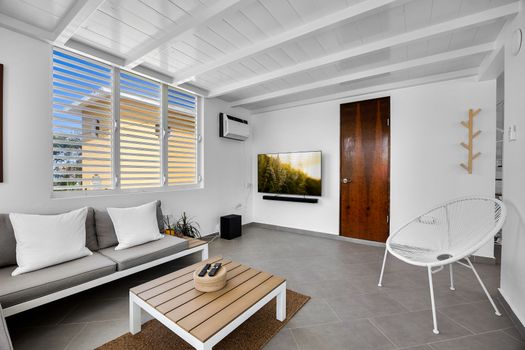 Kick back in the sun-filled lounge, featuring a soft sofa and large window – a perfect space to unwind, read a book, or binge your favorite series in comfort.