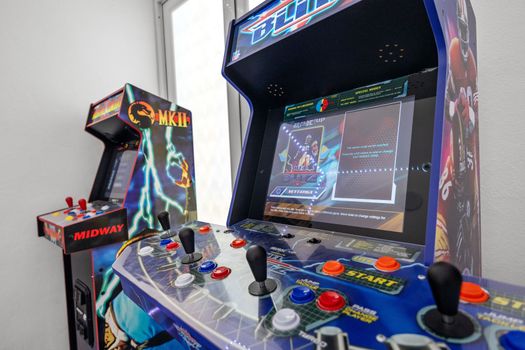 Experience the golden age of gaming with our selection of classic arcade machines amidst contemporary comfort.