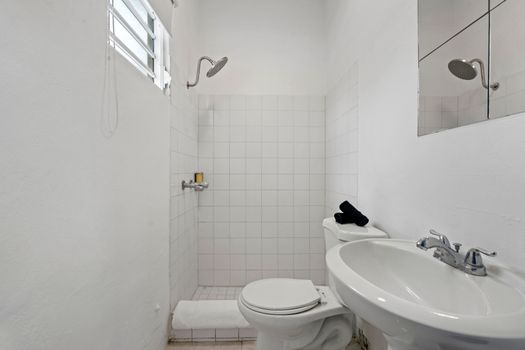 Bright and pristine, our bathroom vanity provides ample space for your personal items. The well-lit mirror ensures you can get ready with ease, adding to your comfort and convenience.