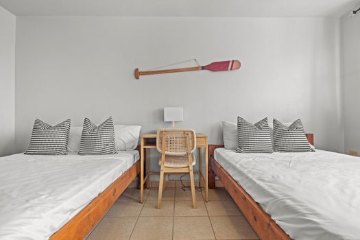 Disfrute de la armonía del diseño minimalista y la comodidad que ofrece nuestra habitación con dos camas bañadas por una refrescante luz natural.