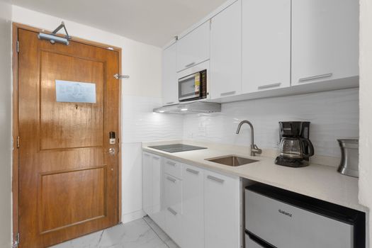 Sleek and fully equipped kitchenette ready for your culinary adventures. Cook with ease and style!