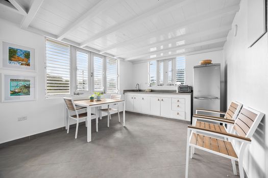 Gather around the chic dining table with easy flow into the open kitchen – fully equipped for guests who enjoy preparing meals or sharing cozy dinners at home.