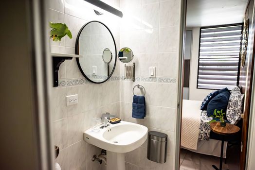 Freshen up with ease at our practical bathroom vanity, complete with a round mirror, extra magnifying mirror, and a convenient towel ring. Everything you need is right at hand.