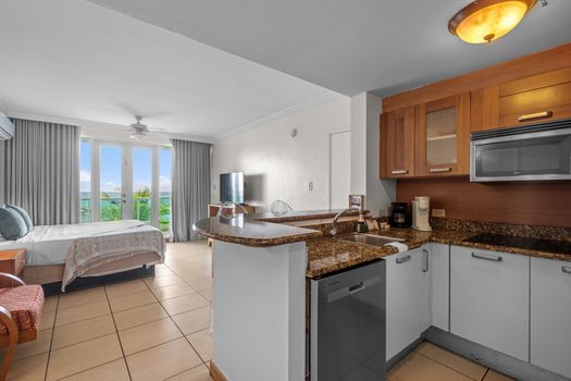 Cook, dine, and relax with ease. The open-concept design allows for fluid movement between the sleeping area, dining space, and the compact yet comprehensive kitchen.